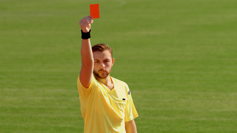 Soccer referee showing the red card